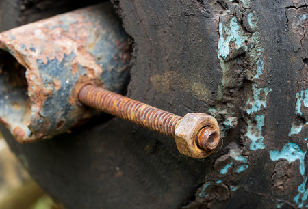 Nut and bolt on a wooden background. Close up detail.の写真素材