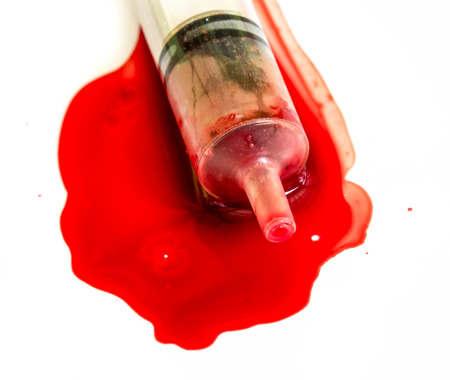 Syringe of Red Blood Test for medical research or Cure the Disease sickness ill such as HIV AIDS Concept Idea isolated on white background.の写真素材