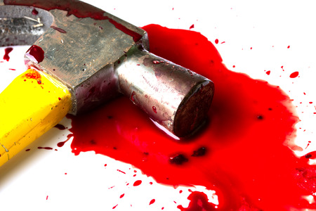 A close-up of a bloody hammer and small blood pool isolated on white.の写真素材