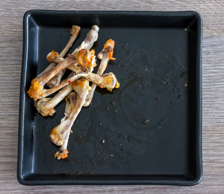 chicken bone on black plate