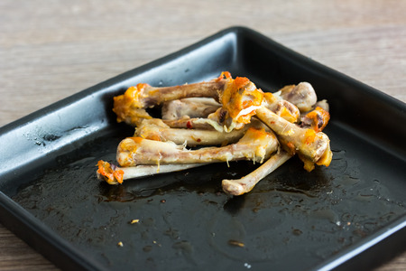 chicken bone on black plateの写真素材