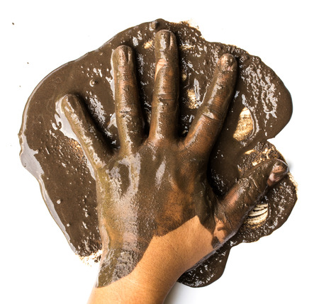 Hands with mud on whiteの写真素材