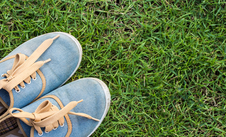 Sneakers on grass, top view, copy spaceの写真素材