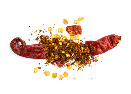 pile crushed red pepper, dried chili flakes and seeds isolated on white backgroundの写真素材