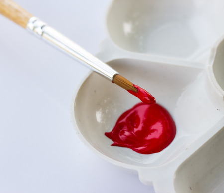 art palette with red color on whiteの写真素材