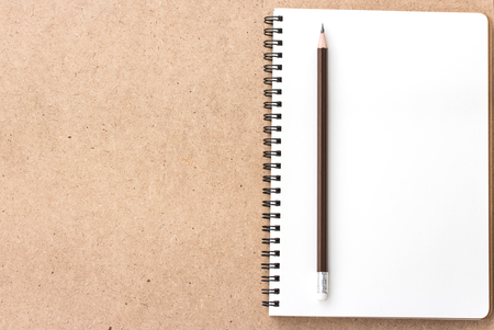 Open Small notepad with pencil and on wood backgroundの写真素材