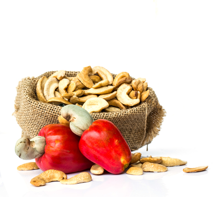 raw cashew nuts and Fresh Cashew Nut pour from sack on whiteの写真素材