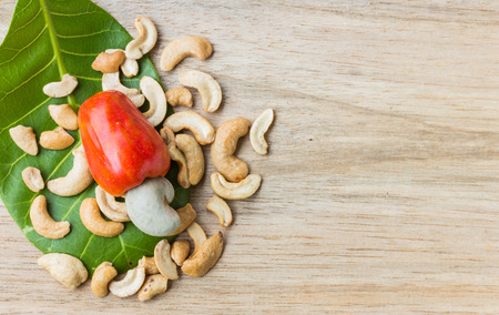 Cashew Nut Apple and Fresh Cashew Nut on woodの写真素材
