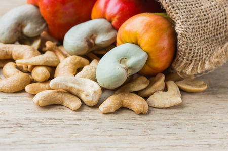 raw cashew nuts Fresh Cashew Nut pour from sack on woodの写真素材