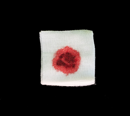 Bandage gauze with blood on black backgroundの写真素材