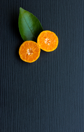 Orange on black wood backgroundの写真素材