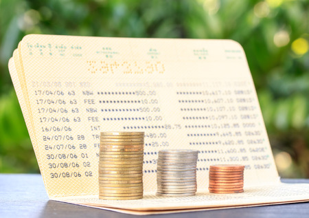 Bank statement with Stacks of coins, investment and saving conceptの写真素材