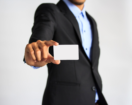 Man holding and showing blank plastic credit card with copy space  on white background.の写真素材