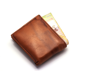 Some Money in brown wallet on white backgroundの写真素材
