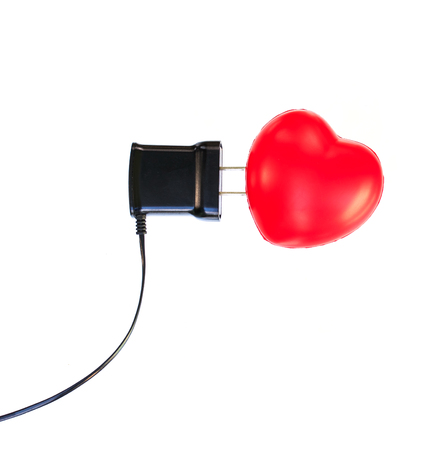 Red Heart and charger on white backgroundの写真素材
