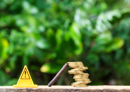 stop sign and Coins are risky on smart phone or cellphone on nature.の写真素材