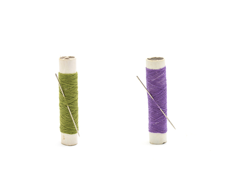 Thread and needle on white background.