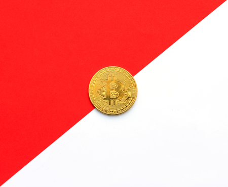 Golden Bitcoin on red and white background - Businessの写真素材