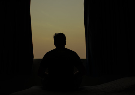 Man meditates while practicing yoga in room. Freedom calmness and relax conceptの写真素材