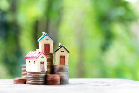 Miniature colourful house on stack coins using as property and finance conceptの写真素材