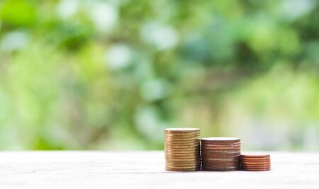 Coin stacks on a nature background