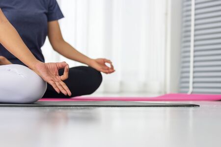 Asian yoga teachers teach students one-on-one in the gym to be healthy and strong.の写真素材