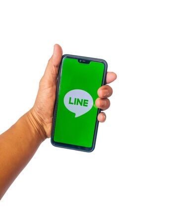Phichit, Thailand - January 11, 2020 : Hands holding phones with applications Line.Line is  An application created by LINE Corporation, the creator of popular chat applications on phones.のeditorial素材