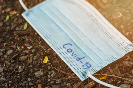 used medical face mask laying on  ground at the street. Dirty face mask.の写真素材
