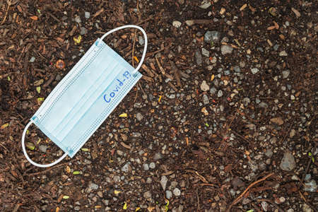used medical face mask laying on  ground at the street. Dirty face mask.の写真素材