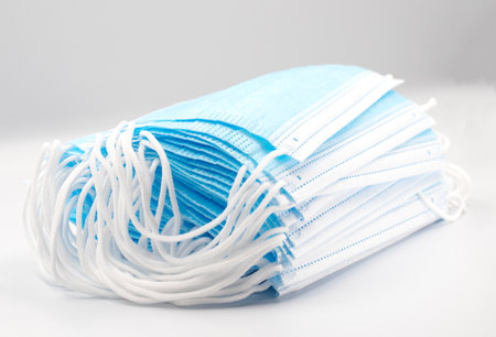 Prevent coronavirus. Medical mask, Medical protective mask isolated on blue background. Disposable surgical face mask cover mouth and nose. Healthcare medical Coronavirus quarantine, hygiene conceptの写真素材