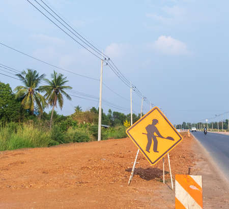 road is under construction and there is a road warning sign.の写真素材