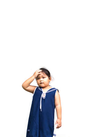 Upset tired, bored girl in blue vest making face palm gesture, feeling bored, disappointed in result of work, bad news. Young child disappointed, helpless  alone on white backgroundの写真素材