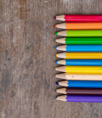 blunt coloured pencils on wood floor.の写真素材