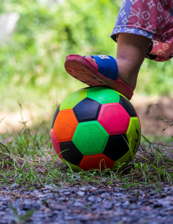 Children's feet on the plateau resting on colorful soccer balls.の写真素材
