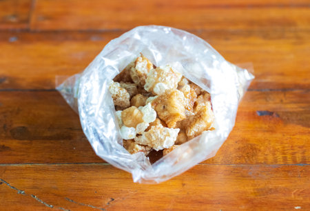 pork snack or crackling food packed in a clear plastic bagの写真素材