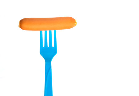 Sausage on fork isolated on white backgroundの写真素材