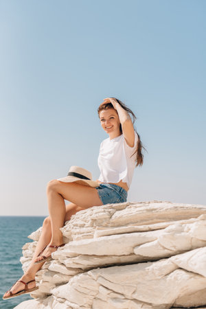 Beautiful girl in shorts and a hat by the sea in Cyprusの写真素材