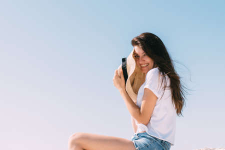 Beautiful girl in shorts and a hat by the sea in Cyprusの写真素材