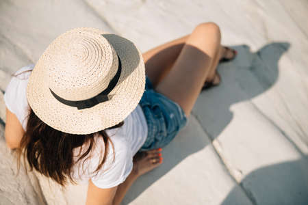 Beautiful girl in shorts and a hat by the sea in Cyprusの写真素材
