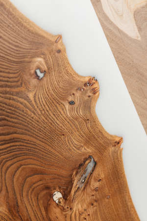 Exclusive handmade table of solid wood and epoxy resin on the background of wood boardsの写真素材