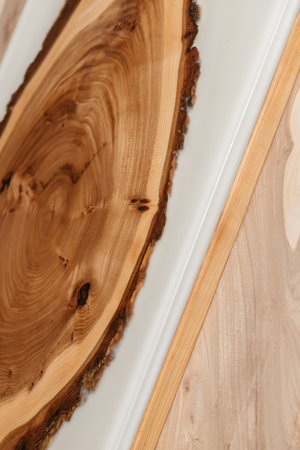 Exclusive handmade table of solid wood and epoxy resin on the background of wood boardsの写真素材