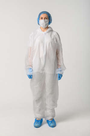 Doctor or nurse in a medical gown, mask and protective glovesの写真素材