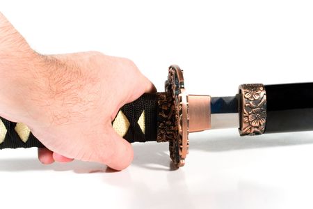 Hand pulling out a Japanese sword from the sheath (on white background)