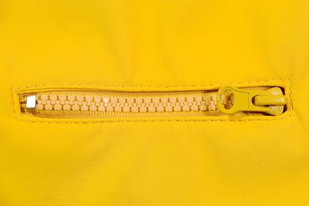 Closeup of a zipper (with bright yellow background)の写真素材