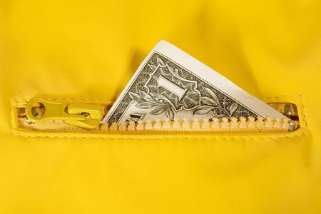 Closeup of a dollar bill in the zipper (with bright yellow background)