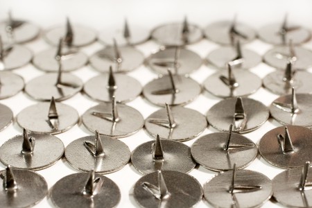 Rows of sharp steel thumbtacks as a background (vintage style)の写真素材