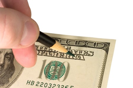 Hand with a pencil and a one-hundred dollar bill (isolated on white)の写真素材