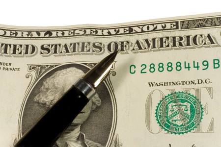 Closeup of a pen on dollar bills (isolated on white)