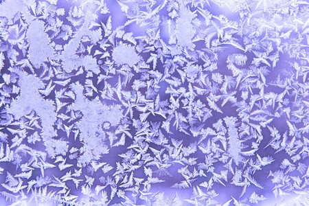 Frostwork on a window glass (as an abstract winter background)の写真素材