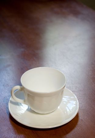 Empty white coffee cup on a wooden tableの写真素材